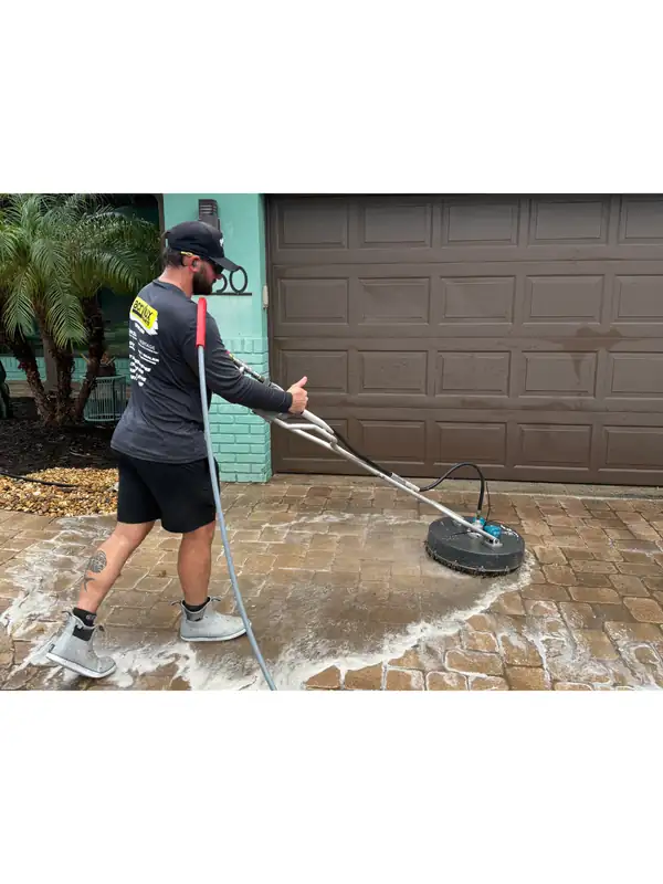 PPW crew member surface cleaning a residential driveway